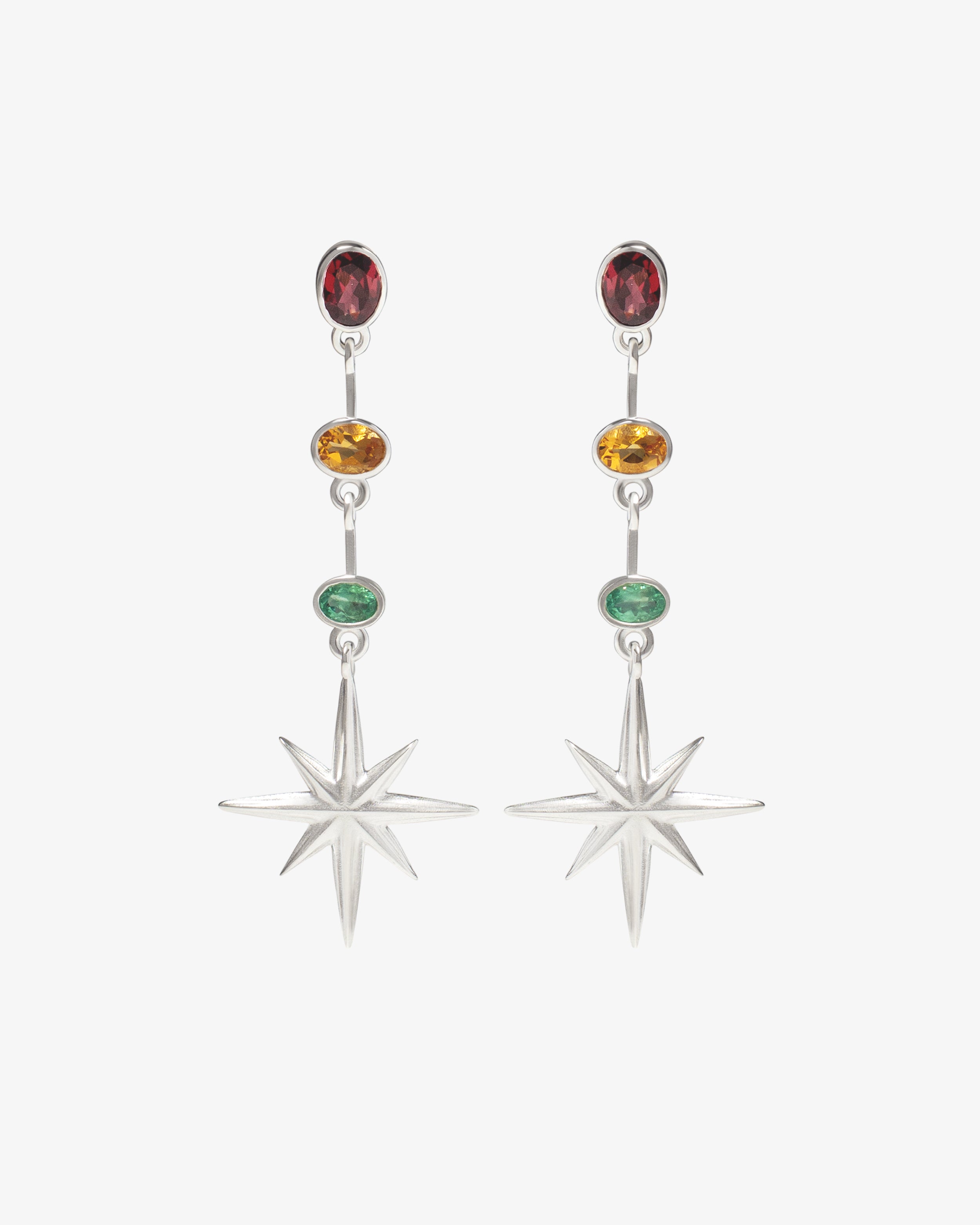 Northern Star silver earrings shown from a second angle, highlighting the vertical drop and eight-pointed star