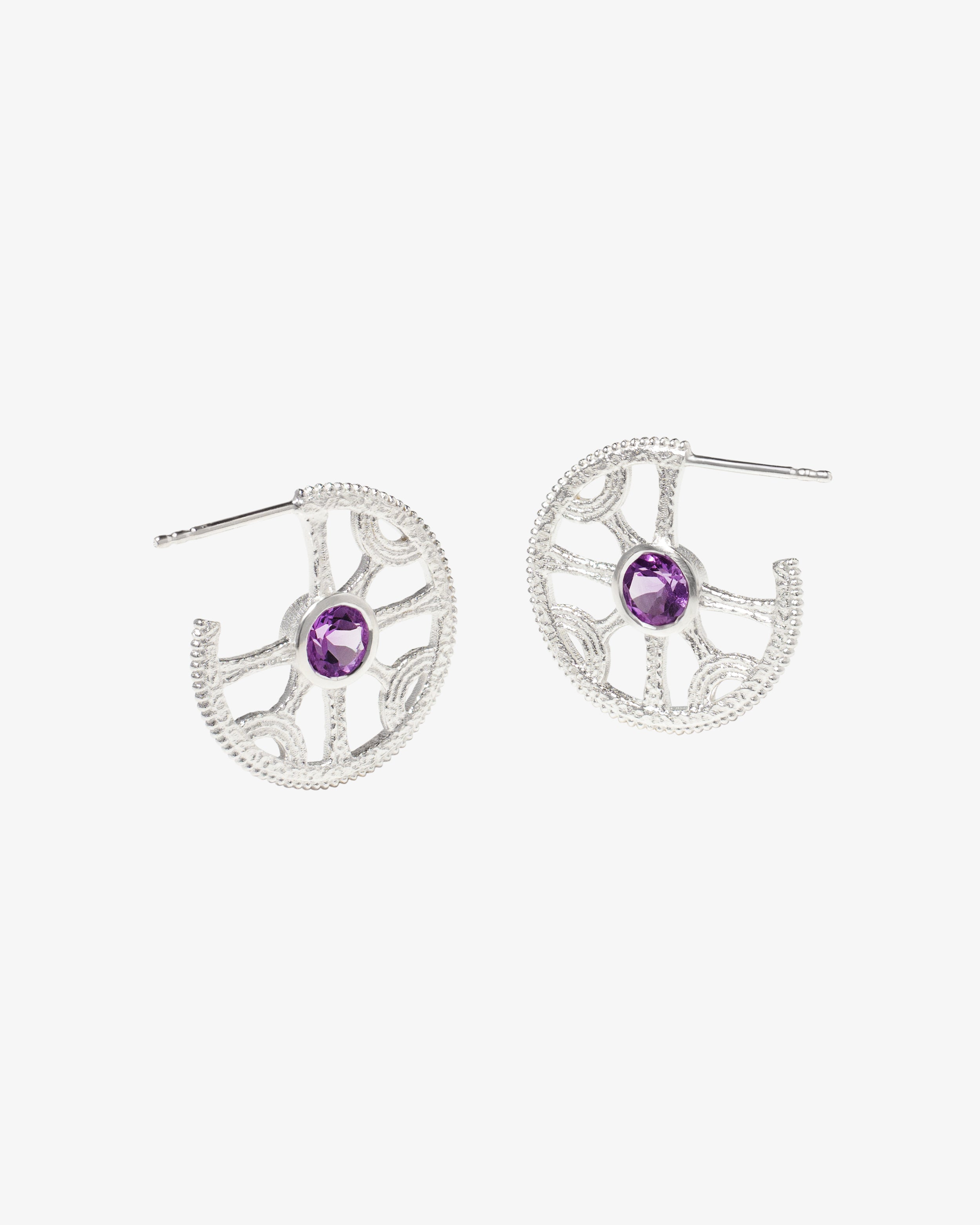 Detail of the silver Sun Wheel earring showing the amethyst and granulated texture