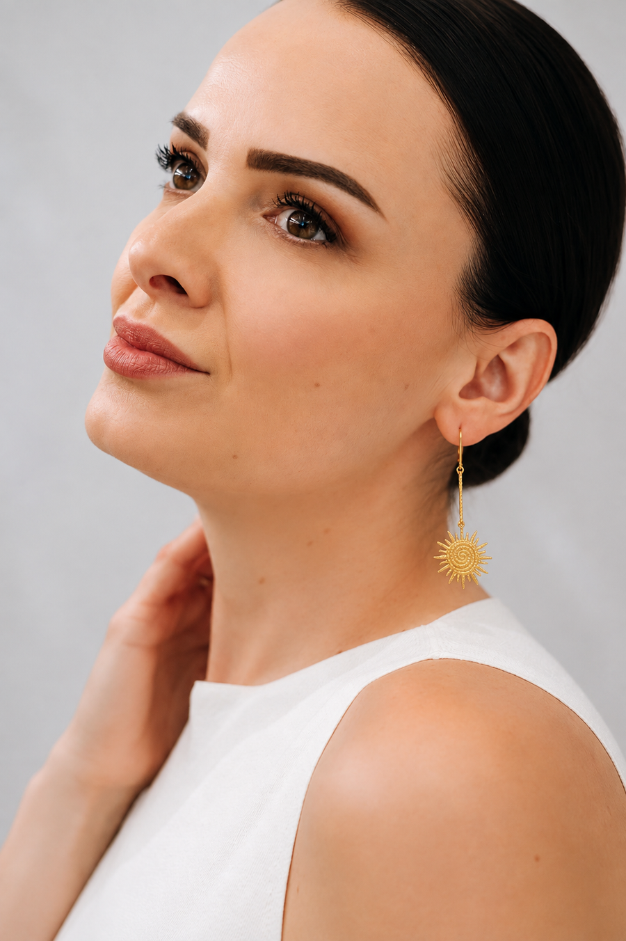 Sunburst earrings in hand-hammered gold vermeil, spiral centre opening into irregular textured rays