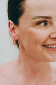 Sun Wheel earrings in hand-textured gold vermeil with granulated edge, bezel-set with sky blue topaz