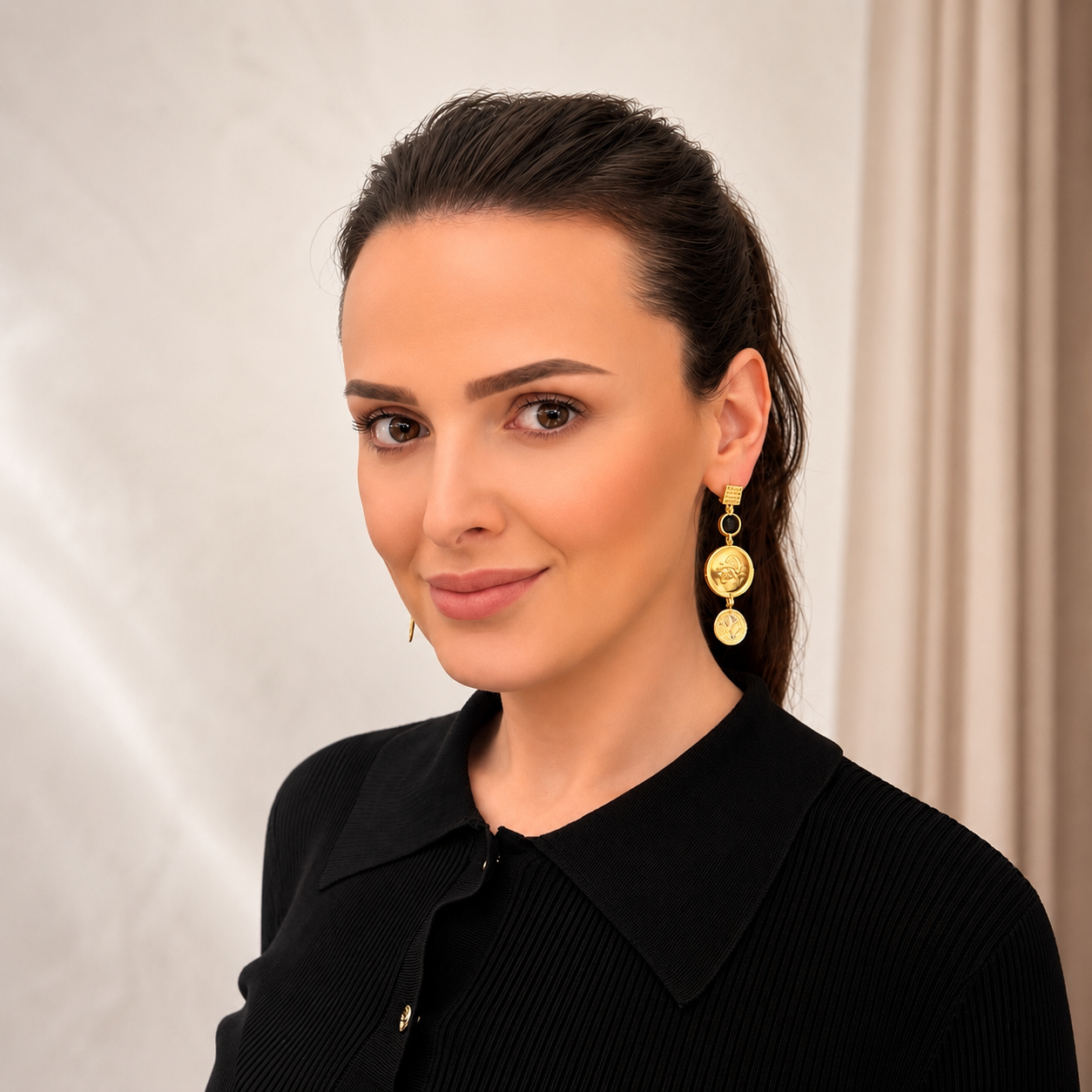 Radiance earrings worn, showing the articulated gold vermeil drops with golden obsidian and white topaz